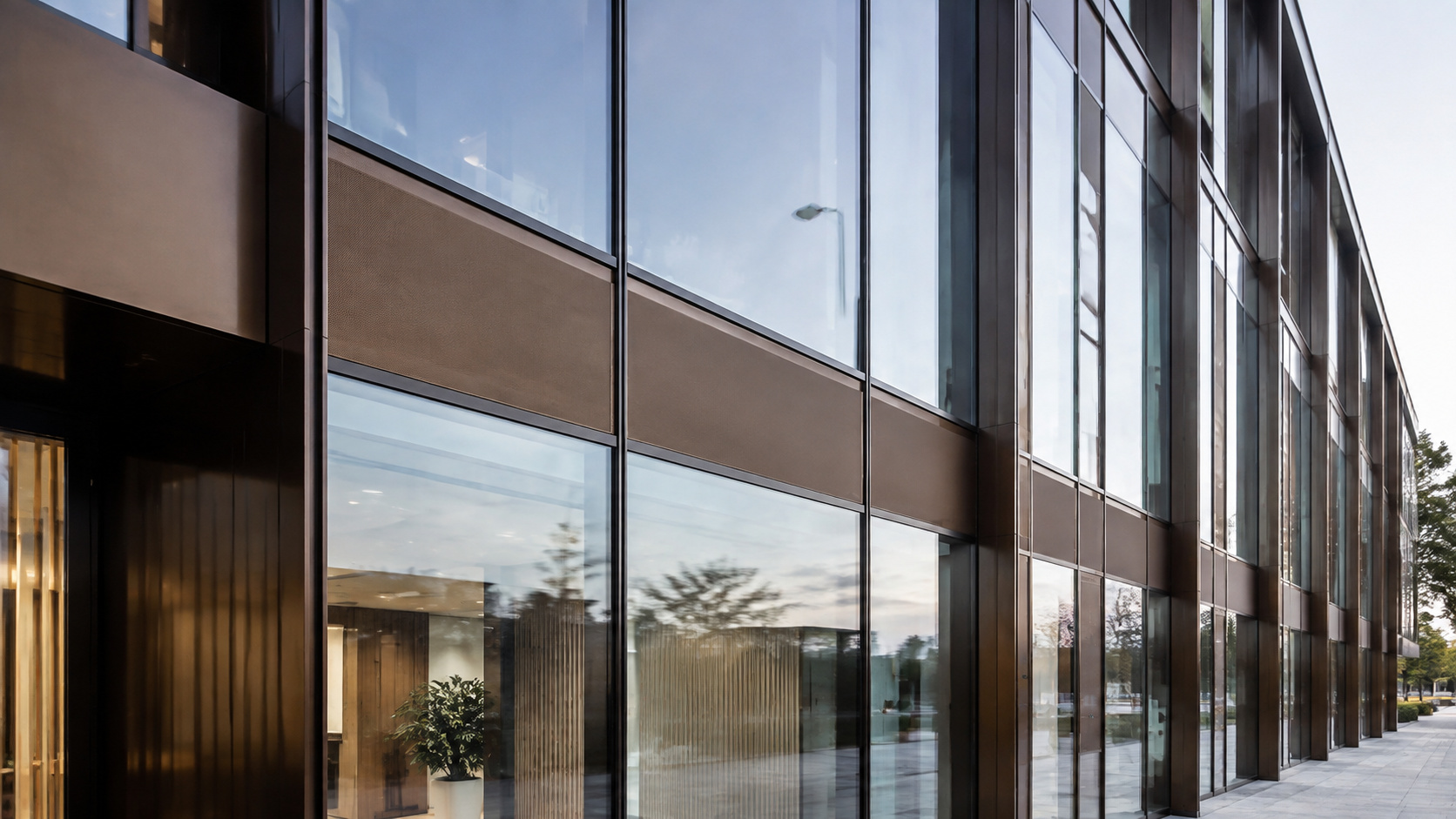Illustrative curtain-wall detail showing glass, mullions and contrasting façade zones